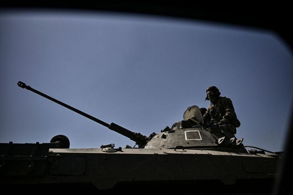 A member of the Ukrainian troops stands on an armored vehicle moving towards the front line in the city of Lysychansk in the eastern Ukraine region of Donbas on June 9, 2022, as Russian forces have for weeks been concentrating their firepower on Severodonetsk and its sister city of Lysychansk across the river.