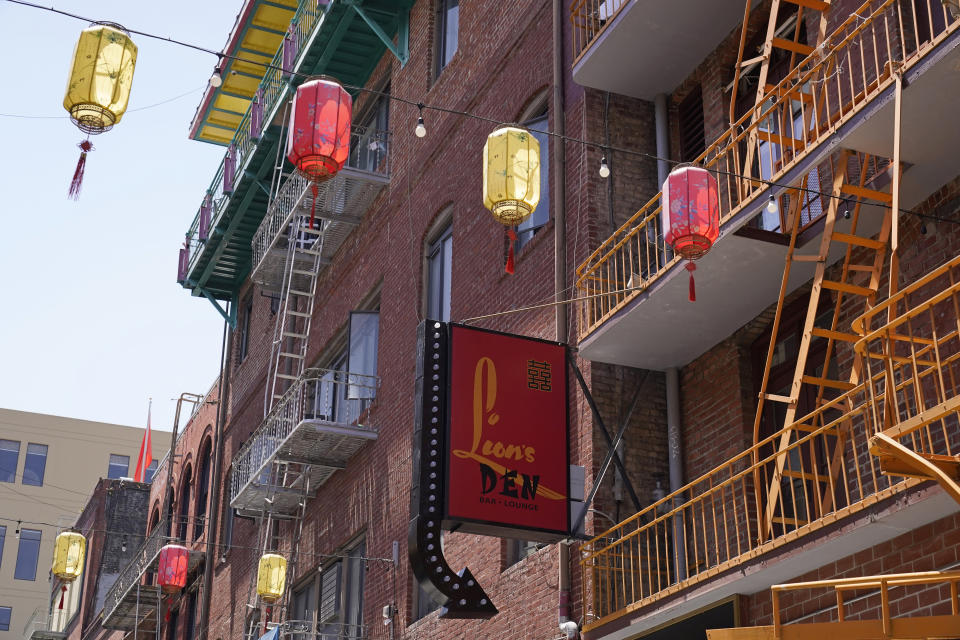 Lanterns hang above the sign to a new Chinatown bar and lounge in San Francisco, Monday, May 23, 2022. Chinatowns and other Asian American enclaves across the U.S. are using art and culture to show they are safe and vibrant hubs nearly three years after the start of the pandemic. From an inaugural arts festival in San Francisco to night markets in New York City, the rise in anti-Asian hate crimes has re-energized these communities and drawn allies and younger generations of Asian and Pacific Islander Americans. (AP Photo/Eric Risberg)