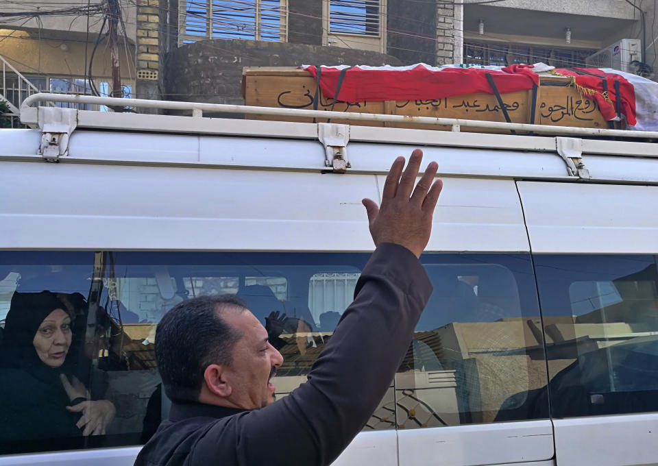 A mourner escorts the flag-draped coffin of Mohammed Jassim, a protester killed in anti-government protests, during his funeral in Baghdad, Iraq, Friday, Nov. 15, 2019. Iraqi medical and security officials say one protester was killed and over 40 were wounded in renewed clashes overnight in central Baghdad. (AP Photo/Khalid Mohammed)