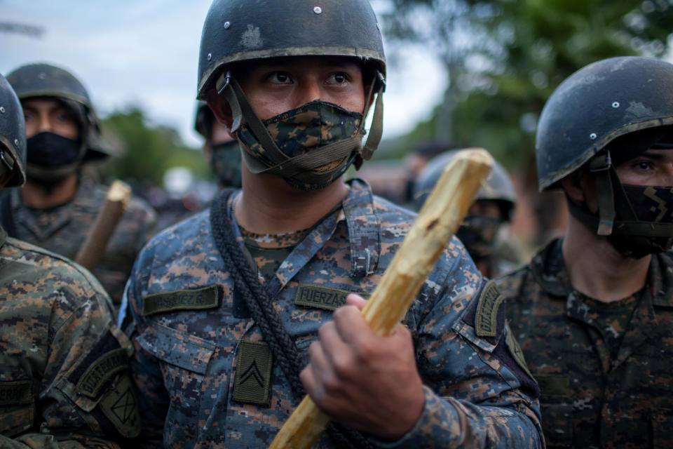 Guatemalan soldiers block part of a Honduran migrant caravan in their bid to reach the U.S. border, in Vado Hondo, Guatemala, Sunday, Jan. 17, 2021.(AP Photo/Sandra Sebastian)