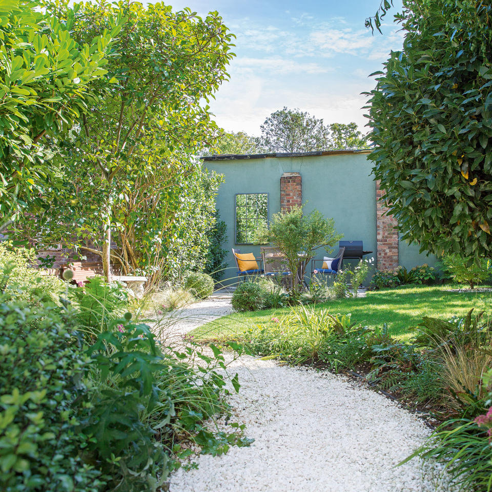 garden pathway with plants and shrubs