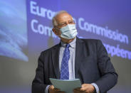 EU foreign policy chief Josep Borrell, wearing a face mask, leaves at the end of a video press conference following the International Donors' Conference in solidarity with Venezuelan refugees and migrants at the EU headquarters in Brussels, Tuesday, May 26, 2020. International donors on Tuesday pledged more than 2.5 billion euros ($2.7 billion) in support for refugees and migrants from Venezuela as the coronavirus pandemic deepens their plight. (Olivier Hoslet, Pool Photo via AP)