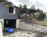 The house owned by Lawrence Police Officer Ivan Soto sits nearly burned to the ground on Jefferson Street, in Lawrence, Mass., Friday, Sept. 14, 2018. It was one of multiple houses that went up in flames on Thursday afternoon after gas explosions and fires triggered by a problem with a gas line that feeds homes in several communities north of Boston. After rushing home to check on his family and warn his neighbors to evacuate, Soto went back on patrol while his house was burning down. (AP Photo/Bob Salsberg)