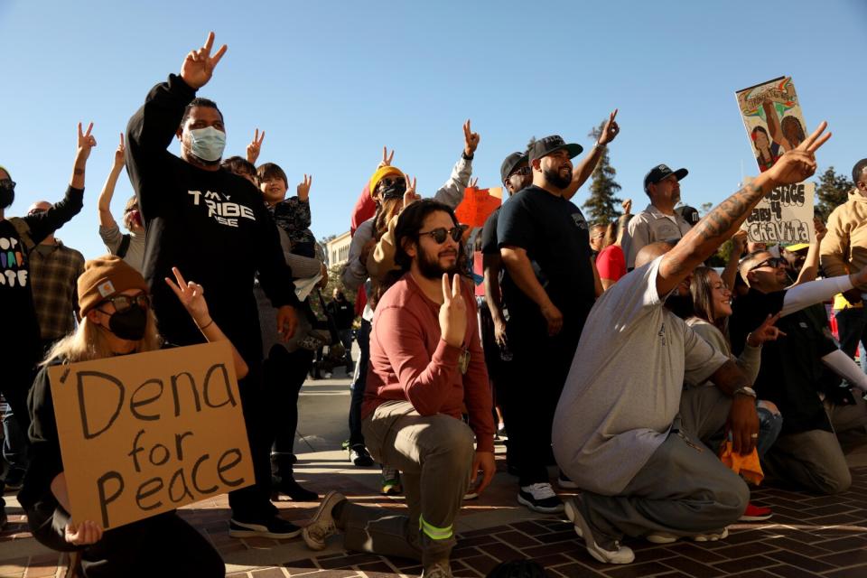 Residents and community activists in Pasadena participate in a rally for peace in front of Pasadena City Hall.