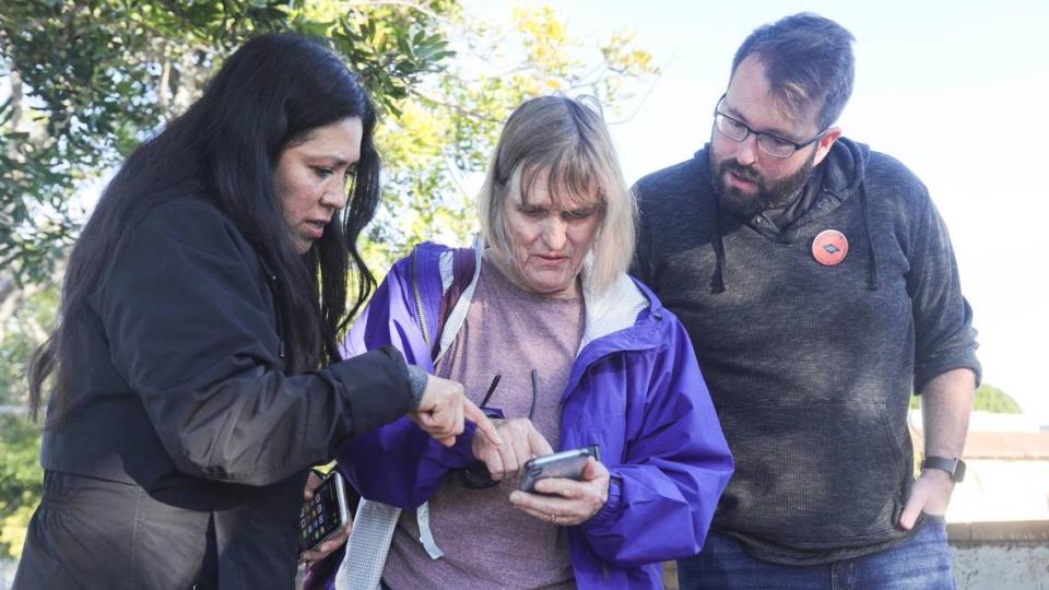 From the left, Miriam Vargas, Karen Blum and Joshua Smith work on survey app used to compile data. The Point-In-Time Count of the county’s unhoused population took place on Jan. 23, 2024.