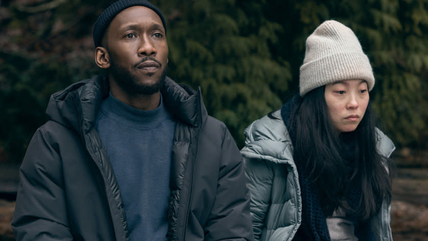 Mahershala Ali sits next to Awkwafina in winter coats