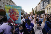 People gather in Black Lives Matter Plaza to celebrate president-elect Joe Biden's win over Pres. Donald Trump to become the 46th president of the United States, Saturday, Nov. 7, 2020, in Washington. His victory came after more than three days of uncertainty as election officials sorted through a surge of mail-in votes that delayed the processing of some ballots. (AP Photo/Alex Brandon)