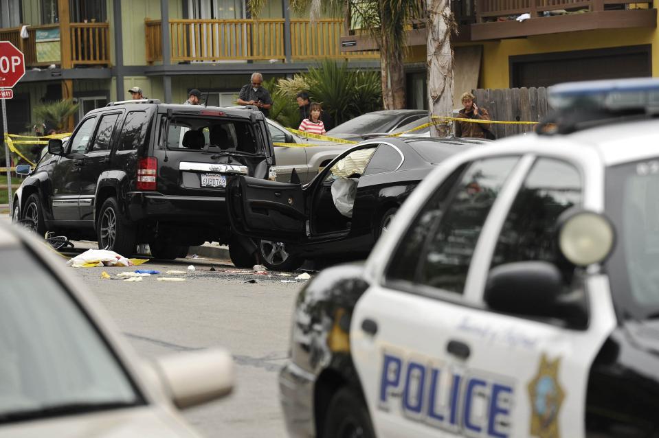 A wrecked black BMW sedan is pictured on the street after series of drive -by shootings that left 6 people dead in the Isla Vista section of Santa Barbara