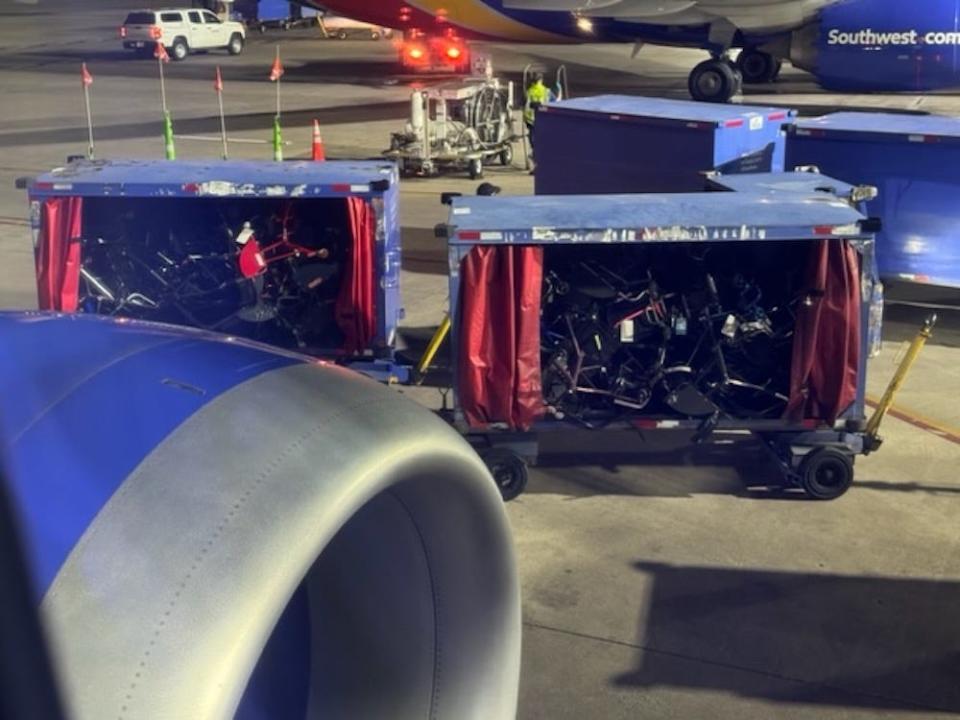 Dozens of disassembled wheelchairs can be seen jumbled up in two transportation carriages, viewed from the window of a Southwest Airlines plane at Richmond International Airport on April 10, 2024.