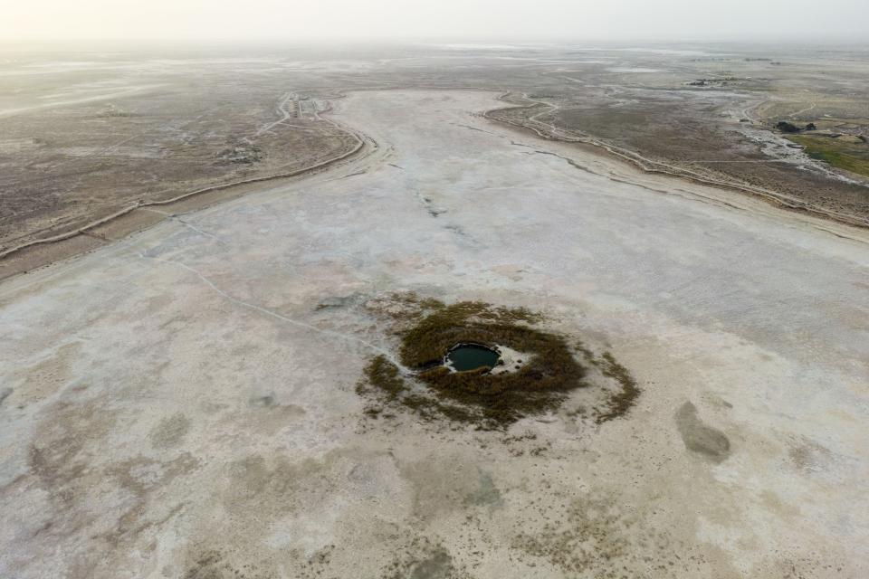 A dried Sawa Lake is surrounded by a dry bed in Iraq, Monday, April 10, 2023. (AP Photo/Anmar Khalil)