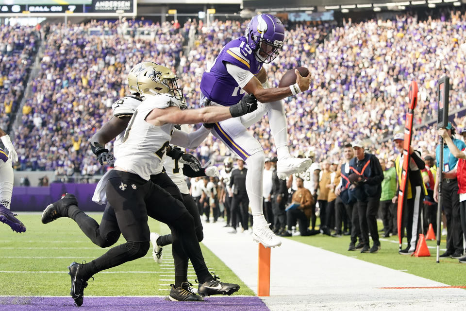 Minnesota Vikings quarterback Joshua Dobbs (15) runs for a touchdown during the first half of an NFL football game against the New Orleans Saints Sunday, Nov. 12, 2023, in Minneapolis. (AP Photo/Abbie Parr)