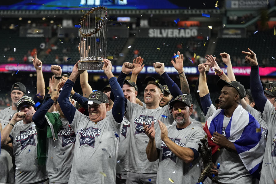FILE - Atlanta Braves manager Brian Snitker holds up the trophy after the Braves defeated the Houston Astros 7-0 in Game 6 of the baseball World Series on Nov. 2, 2021, in Houston. (AP Photo/David J. Phillip, File)