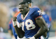 FILE - IN this Jan. 30, 1994 file photo, Buffalo Bills' Bruce Smith holds up his injured hand during the third quarter of Super Bowl XXVIII against the Dallas Cowboys in Atlanta. Smith is happy seeing the Buffalo Bills finally back in the AFC championship game for the first time in 27 years. What excites him more is a belief the team seems poised for long-term success in drawing comparisons of Buffalo's team in 1988, which would eventually go on to make, and lose, four straight Super Bowl appearances starting in '91. (AP Photo /John J. Gaps III, File)