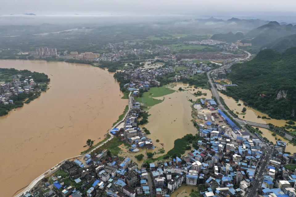 In this photo released by Xinhua News Agency, an aerial view shows a flooded areas along the Rongjiang River after heavy rainfalls in the Rongshui Miao Autonomous County, southern China's Guangxi Zhuang Autonomous Region, June 4, 2022 . China regularly experiences flooding during the summer months, most frequently in central and southern areas that tend to receive the most rainfall. (Huang Xiaobang/Xinhua via AP)