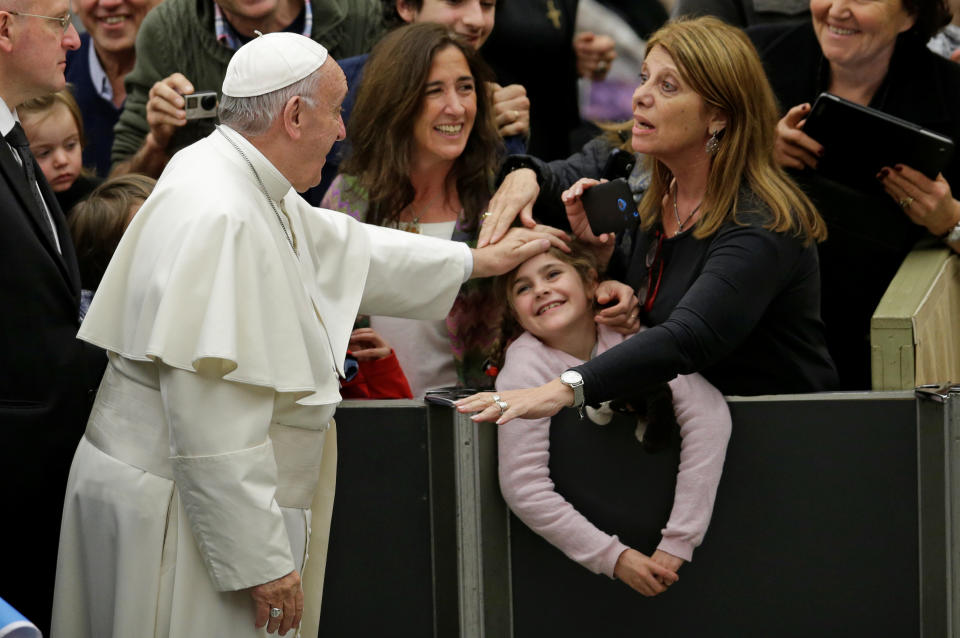 Pope Francis greets a family as he arrives to lead the general audience in Paul VI Hall at the Vatican December 7, 2016. REUTERS/Max Rossi