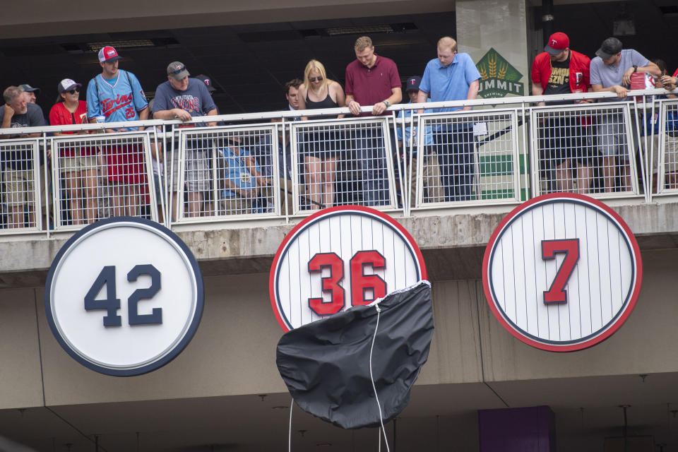 Fans watch as Minnesota Twins former pitcher Jim Kaat's retired number, 36, is unveiled during a ceremony before their game against he Chicago White Sox, Saturday, July 16, 2022, in Minneapolis. Kaat will be inducted into the Baseball Hall of Fame later this month. (AP Photo/Craig Lassig)