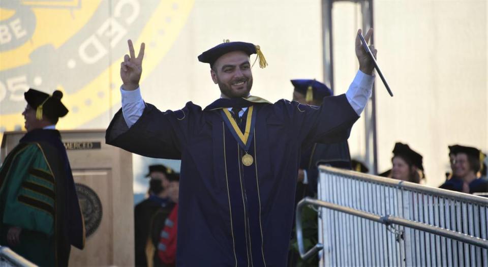 UC Merced graduate student Karen Mohammadtabar raises his arms in the air after receiving his Ph. D in Philosophy Mechanical Engineering during UC Merced’s spring commencement ceremony on Friday, May 12, 2023. Shawn Jansen/Sjansen@mercedsun-star.com