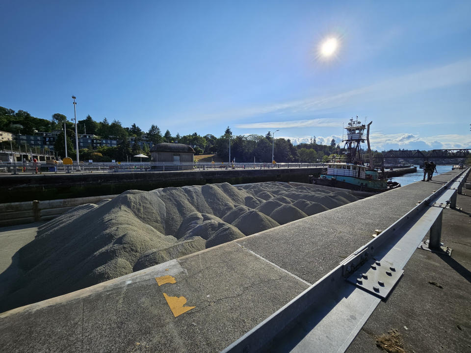 A boat moving mounds of dirt