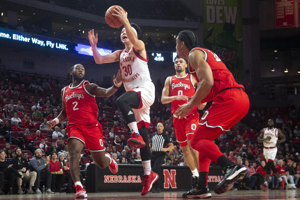 Nebraska's Keisei Tominaga (30) goes to the basket, next to Ohio State's Bruce Thornton, left, during the first half of an NCAA college basketball game Wednesday, Jan. 18, 2023, in Lincoln, Neb. (Justin Wan/Lincoln Journal Star via AP)