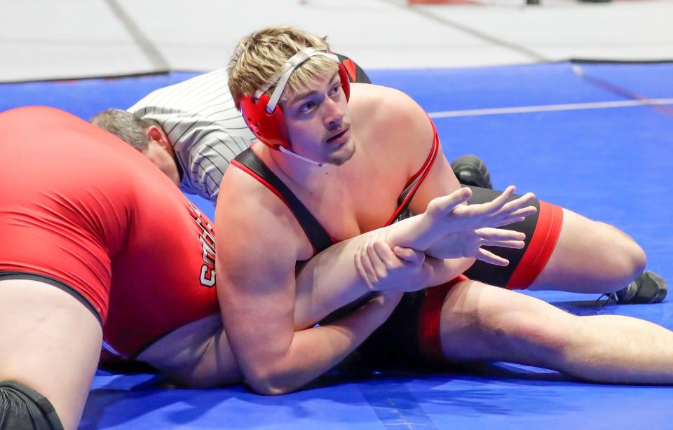 Muskego’s Dominic Schnier grips Wisconsin Rapids Lincoln’s Tanner Gormanson in 285-pound match during a Division 1 semifinal dual  Friday at the UW Field House.