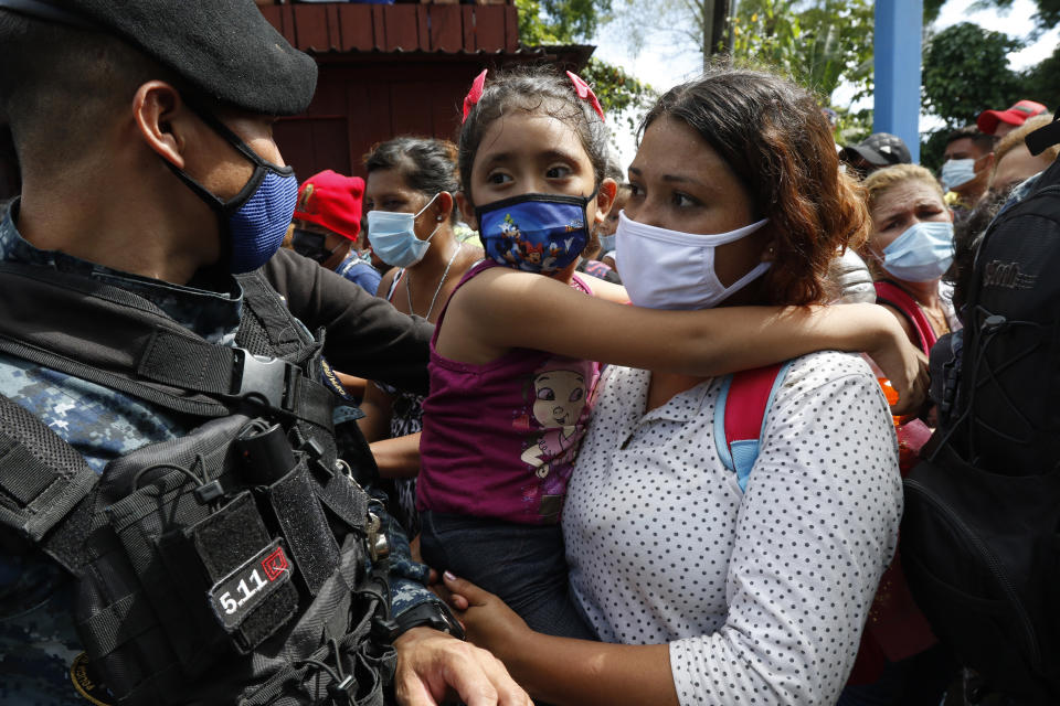 Migrants attempt to cross the border from Corinto, Honduras, into Corinto, Guatemala, Thursday, Oct. 1, 2020. Hundreds of migrants walked from San Pedro Sula, Honduras to the Guatemala border, testing a well-trod migration route now in times of the new coronavirus. (AP Photo)