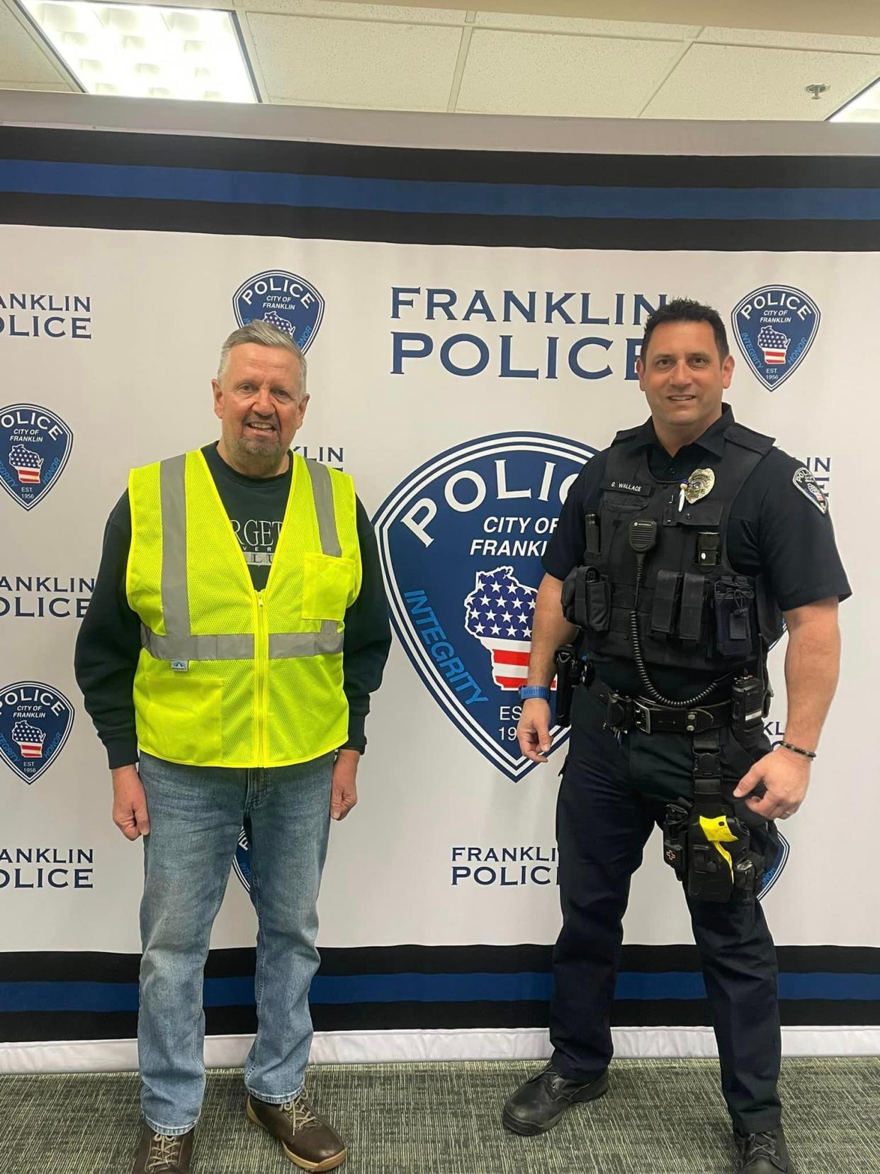 Don Schwartz (left) launched Operation: Safe Strides to distribute reflective vests to residents in Franklin. Schwartz is shown with Franklin Police Officer Gary Wallace who helped with the effort.