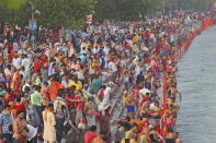 Devotees take holy dips in the river Ganges during Shahi snan or a Royal bath at Kumbh mela, in Haridwar in the Indian state of Uttarakhand, Monday, April 12, 2021. As states across India are declaring some version of a lockdown to battle rising Covid cases as part of a nationwide second-wave, thousands of pilgrims are gathering on the banks of the river Ganga for the Hindu festival Kumbh Mela. The faithful believe that a dip in the waters of the Ganga will absolve them of their sins and deliver them from the cycle of birth and death. (AP Photo/Karma Sonam)