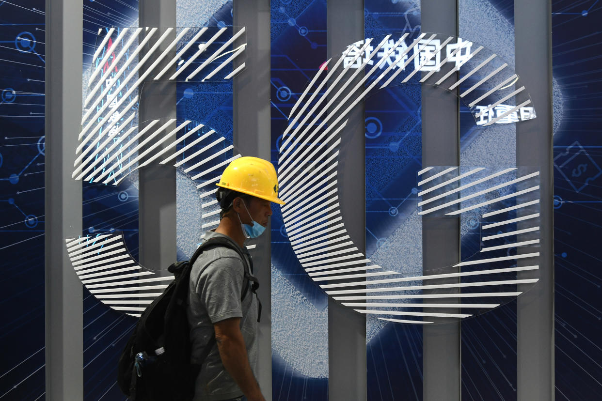 GUANGZHOU, CHINA - NOVEMBER 25: A man walks past a 5G sign before the 2020 World 5G Convention at Nan Fung International Convention & Exhibition Center on November 25, 2020 in Guangzhou, Guangdong Province of China. The 2020 World 5G Convention will be held on November 26-28 in Guangzhou. (Photo by VCG/VCG via Getty Images)