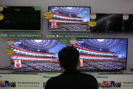 A man watches a broadcast of Chinese President Xi Jinping delivering his speech during the opening of the 19th National Congress of the Communist Party of China, at an electronics store in Liuzhou, Guangxi Zhuang Autonomous Region, China October 18, 2017. REUTERS/Stringer