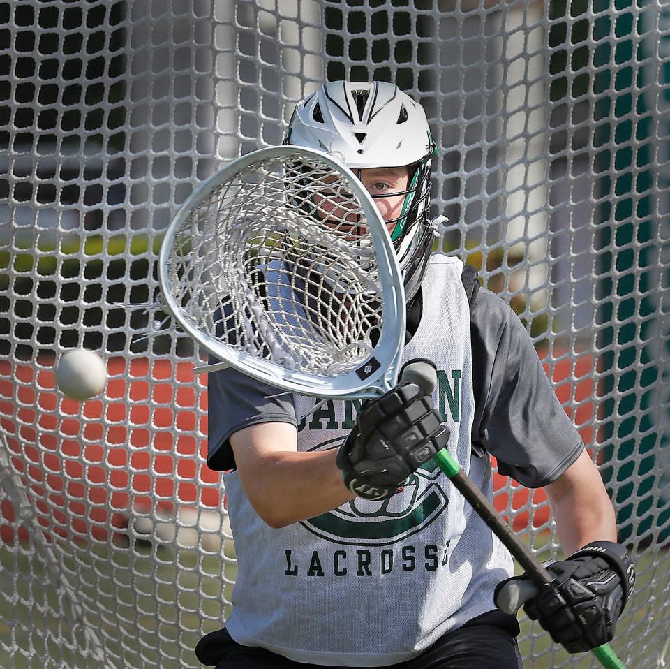 Canton High boys lacrosse sophomore Patrick Drury, one of Canton’s best attackman, volunteered to play in goal after the graduation of league MVP Dylan Coyne last year. Drury tracks a ball during practice on Wednesday, May 25, 2022.