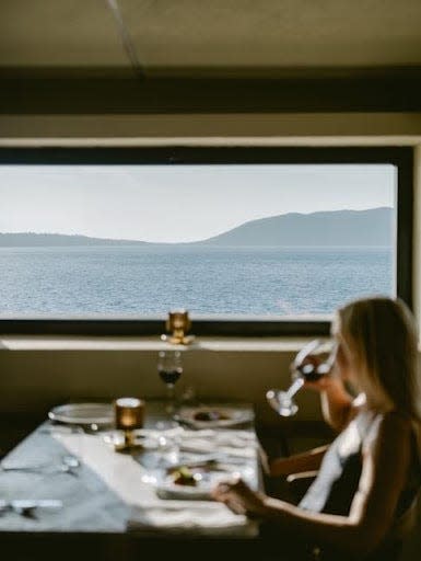 A woman eats by a window at one of the restaurants at the Mamula Island Hotel.