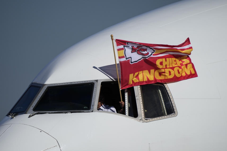 A Kansas City Chiefs flag flies from the team plane as they arrive ahead of Super Bowl 57, Sunday, Feb. 5, 2023, in Phoenix. The Kansas City Chiefs will play the Philadelphia Eagles on Sunday.(AP Photo/Matt York)