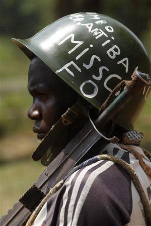 A fighter from the Christian "anti-balaka" militia wearing a helmet stands at the headquarters in the northern Bangui suburb of Boeing, an area near the Mpoko International Airport of Bangui February 22, 2014. REUTERS/Luc Gnago