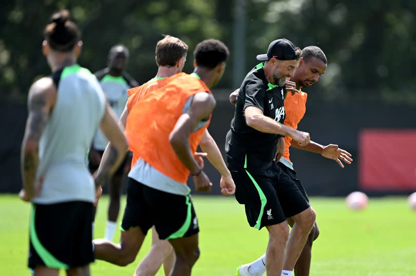 Jürgen Klopp manager of Liverpool playing football with Joël Matip of Liverpool during a training session on July 17, 2023 in Germany.