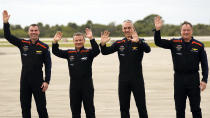 Axiom-3 mission astronauts, from left, mission specialist Marcus Wandt, of Sweden, mission specialist Alper Gezeravci, of Turkey, pilot Walter Villadei, of Italy, and Commander Michael Lopez-Alegria wave to family after arriving at the Kennedy Space Center, Thursday, Jan. 18, 2024, in Cape Canaveral, Fla., to prepare for this afternoon's launch to the International Space Station. (AP Photo/John Raoux)