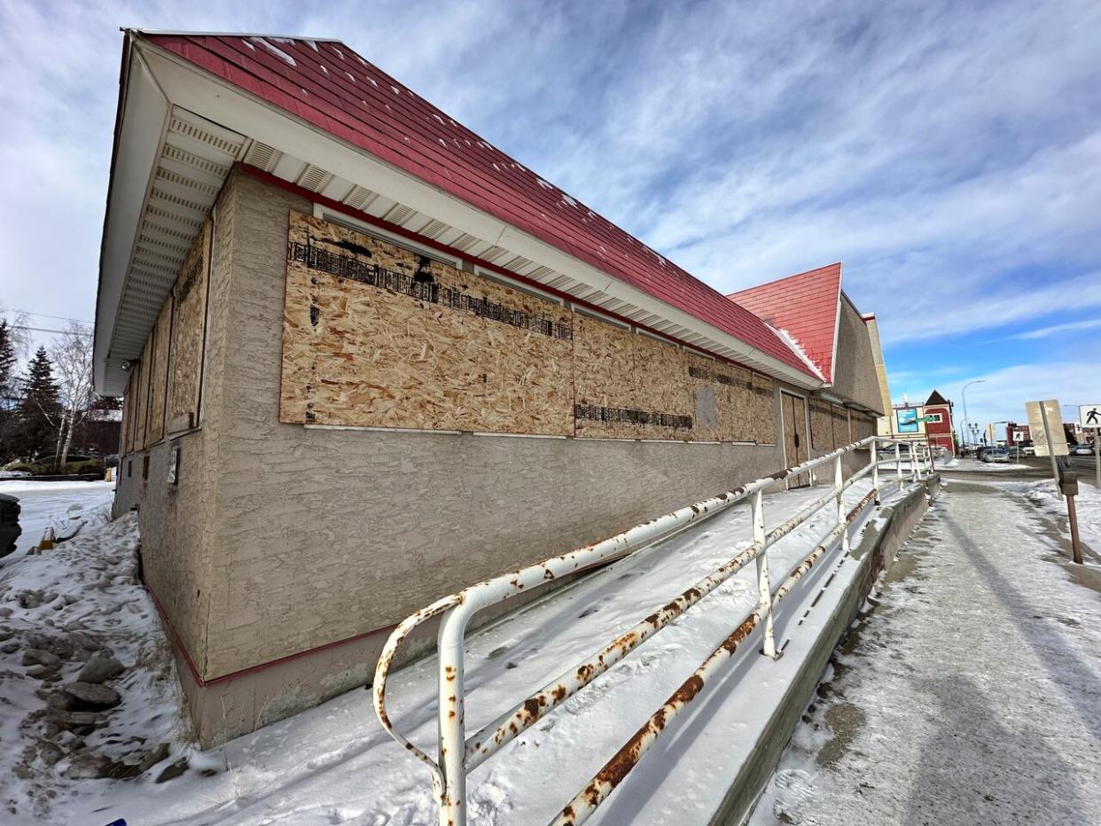 A boarded up building at 2098 Second Avenue in Whitehorse. On Tuesday night city councillors had their first look at a new vacant and abandoned buildings bylaw. It's designed to discourage people from leaving buildings empty.  (Gabrielle Plonka/CBC - image credit)