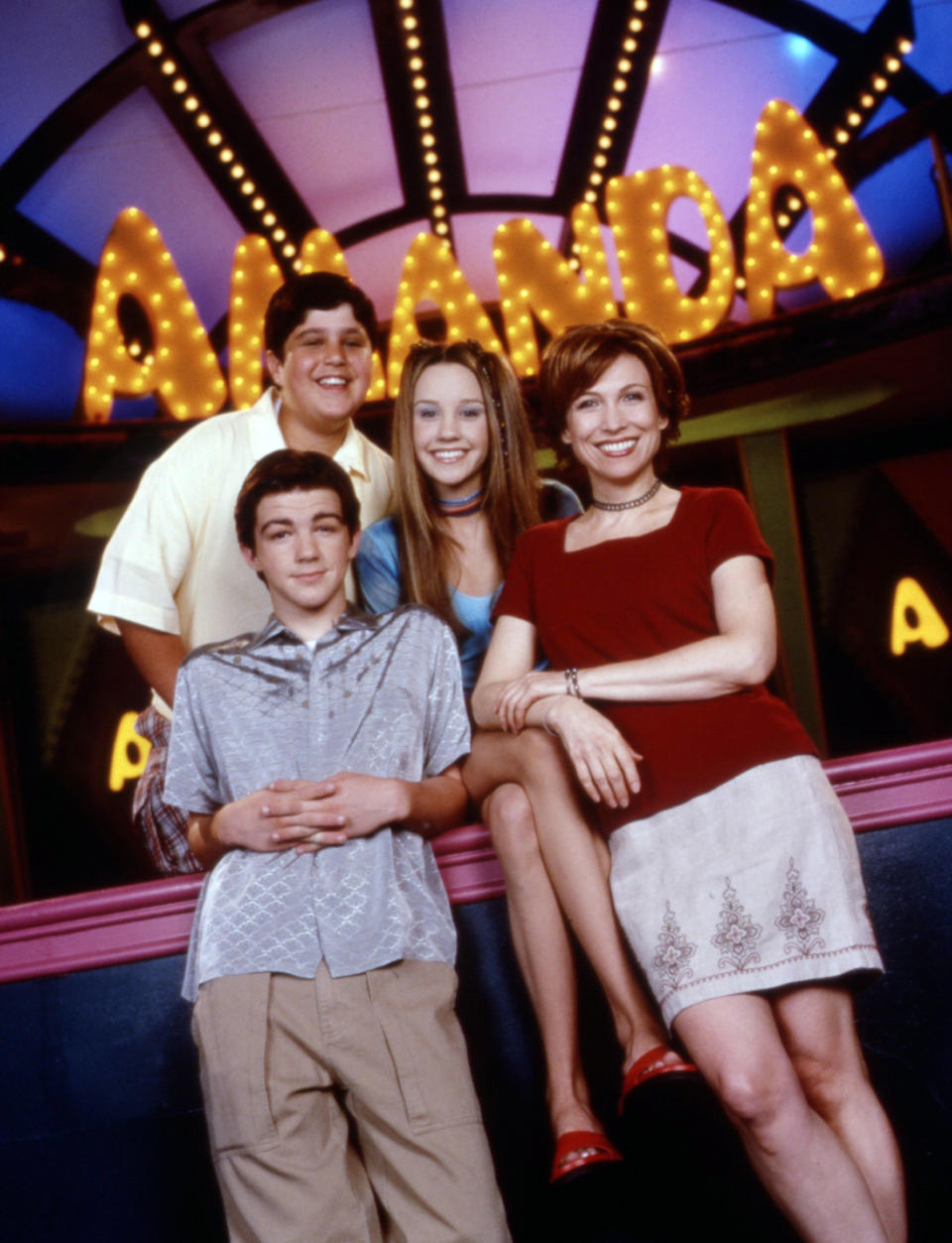 Promotional photo of "The Amanda Show" cast members, posing with neon sign above