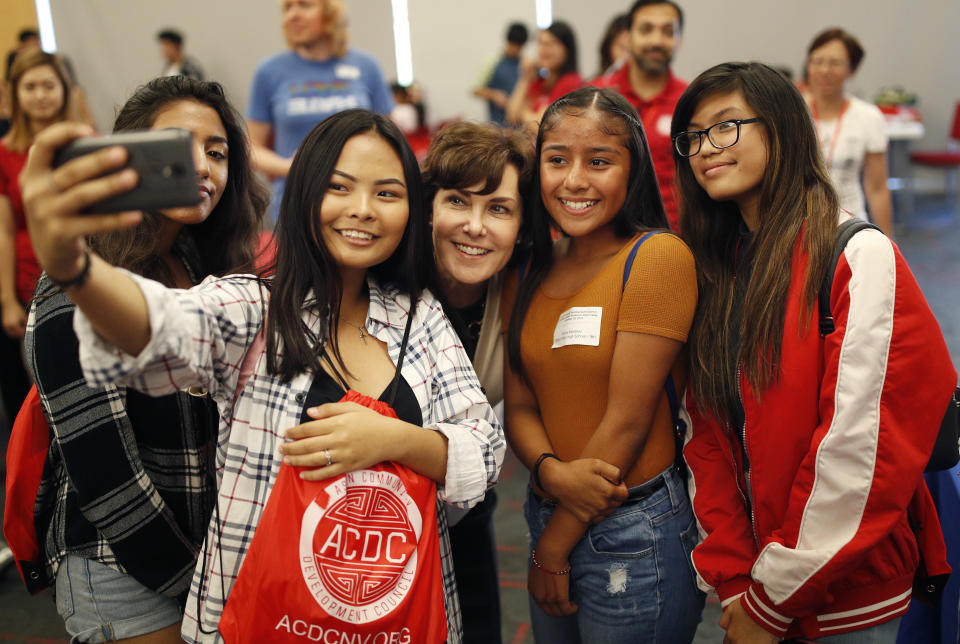 In this Sept. 29, 2018, photo, Rep. Jacky Rosen, D-Nev., center, poses for a selfie with high school students at an event put on by the Asian Community Development Council in Las Vegas. In the high-stakes race for Senate in Nevada, Rosen is taking on one of the biggest names in GOP politics by painting Sen. Dean Heller as someone without firm principles. (AP Photo/John Locher)