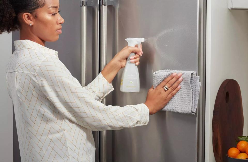 a model using the product on a fridge door