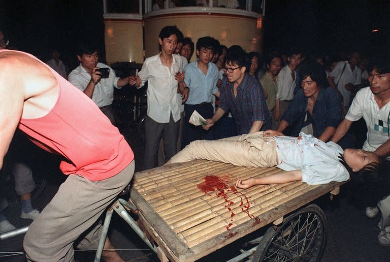 This photo taken on June 4, 1989 shows a girl wounded during clashes between the army and students near Tiananmen Square in Beijing. The dissident author and poet Liao Yiwu was imprisoned a year later for writing a poem about it