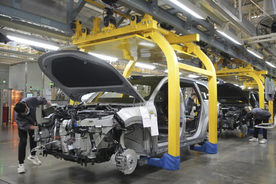 A worker assembles an SUV at a car plant of Li Auto, a major Chinese EV maker, in Changzhou in eastern China's Jiangsu province on Wednesday, March 27, 2024. Manufacturing in China expanded in March after contracting for five consecutive months, according to an official survey of factory managers released Sunday, suggesting a rebound in industrial activities following the Lunar New Year holiday. (Chinatopix Via AP)