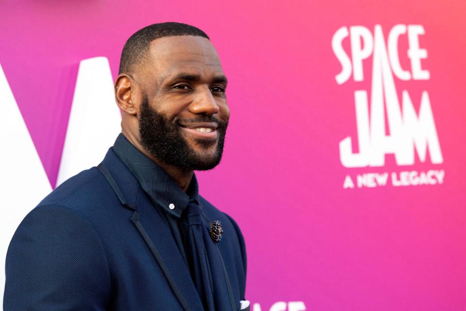TOPSHOT - Basketball player/actor LeBron James arrives at the Warner Bros Pictures world premiere of 