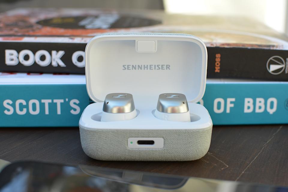 <p>White/silver Sennheiser Momentum True Wireless 4 earbuds sitting in their case with the lid open, photo taken from the front.</p>
