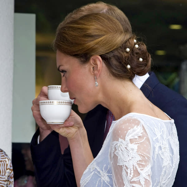 <b>Kate Middleton Top 10 Best Hairstyles:</b> The Duchess of Cambridge showed off a chic, twisted bun style with pearl pins during the couple's tour in Asia in September ©Rex