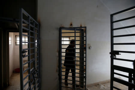 A member of Iraqi Counter-Terrorism Service (CTS) inspects a location used by Islamic State militants as a prison in Mosul, Iraq January 23, 2017. REUTERS/Ahmed Jadallah