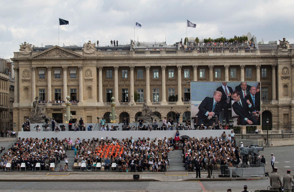 <p>Donald Trump and French President Emmanuel Macron are seen on a large screen during Bastille Day parade on the Champs Elysees avenue in Paris, Friday, July 14, 2017. (Photo: Carolyn Kaster/AP) </p>