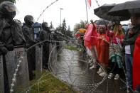 Protesters argue with police standing in front of a police barricade blocking opposition rally from moving toward the Independence Palace, residence of the President Alexander Lukashenko in Minsk, Belarus, Sunday, Sept. 6, 2020. Sunday's demonstration marked the beginning of the fifth week of daily protests calling for Belarusian President Alexander Lukashenko's resignation in the wake of allegedly manipulated elections. (AP Photo)