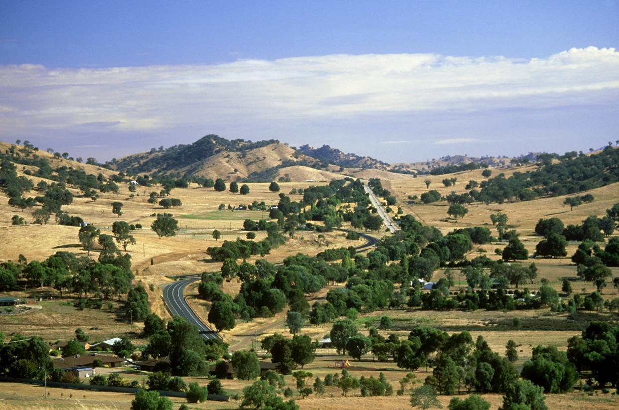 Drive time: above, the Hume Highway, as it snakes through Gundagai, New South Wales. Below left, the white sands of Hyams Beach, on a detour to Jervis Bay: Getty Images