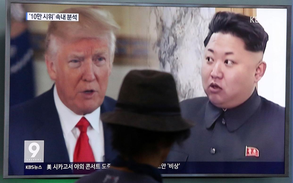 In this Aug. 10, 2017, file photo, a man watches a television screen showing U.S. President Donald Trump, left, and North Korean leader Kim Jong Un during a news programme at the Seoul Train Station in Seoul, South Korea - AP