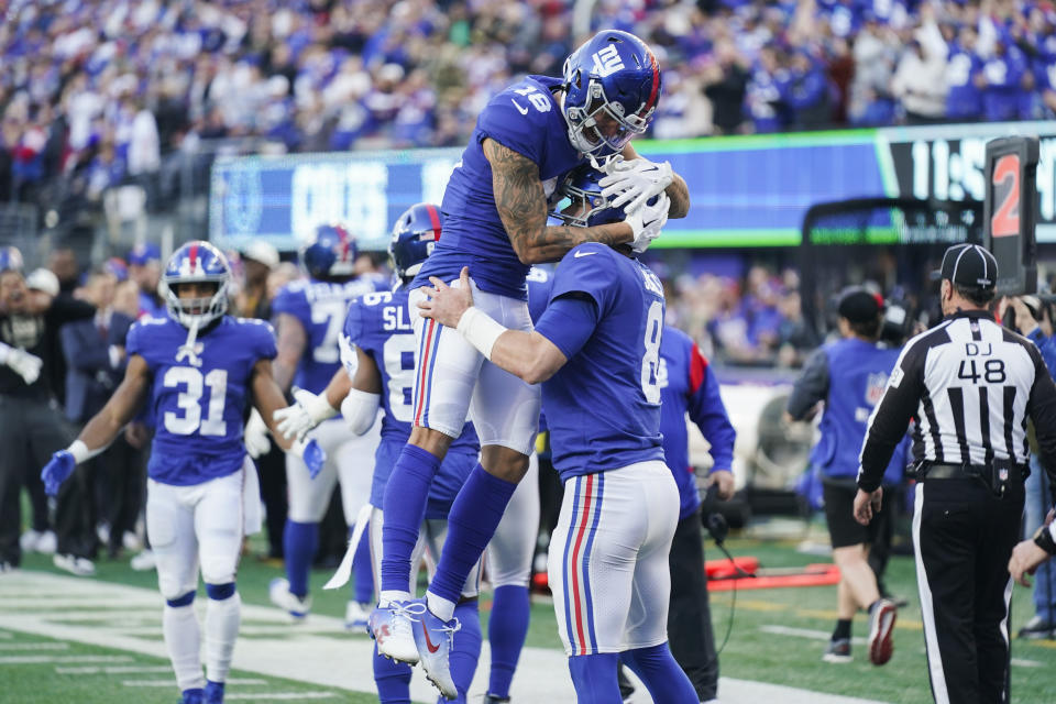 New York Giants' Isaiah Hodgins (18) celebrates with quarterback Daniel Jones (8) after Jones rushed for a touchdown during the second half of an NFL football game against the Indianapolis Colts, Sunday, Jan. 1, 2023, in East Rutherford, N.J. (AP Photo/Seth Wenig)